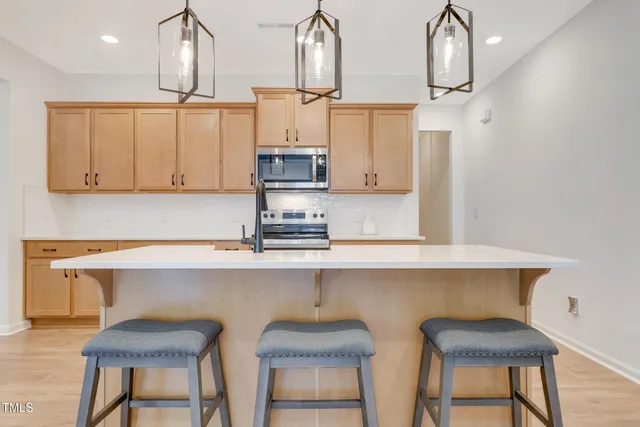 a kitchen with stainless steel appliances a sink and cabinets