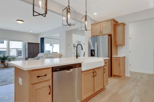 a kitchen with a sink dishwasher a refrigerator and a stove