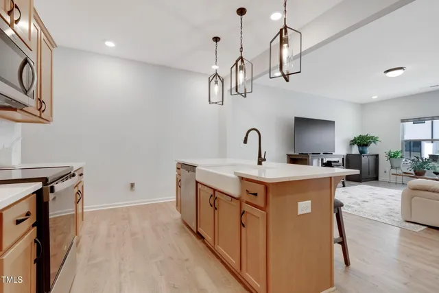 a kitchen with a stove and a wooden floor