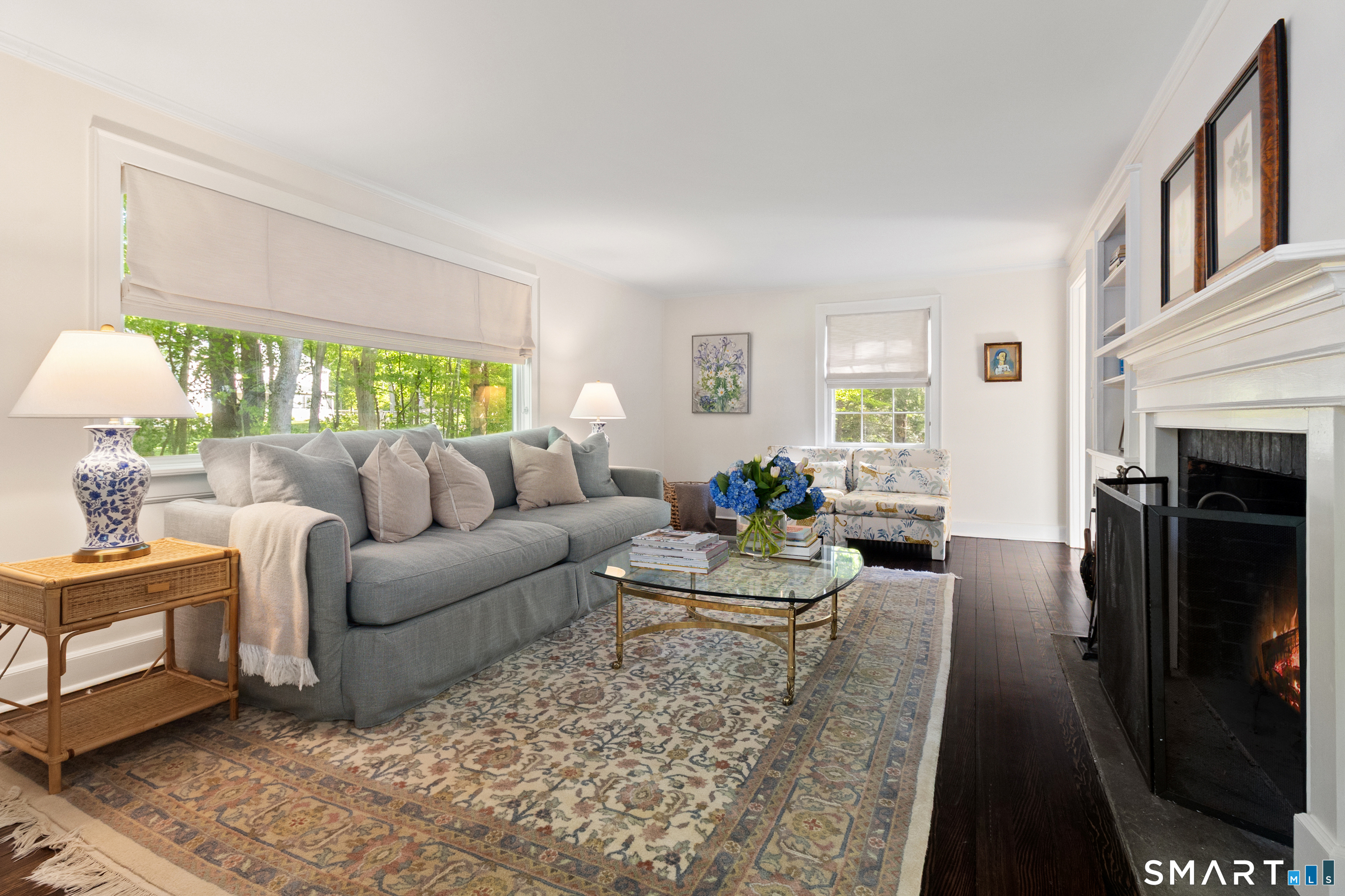 493 Valley Road New Canaan, CT 06840 - Photo 9 of 28 a living room with furniture fireplace and a large window