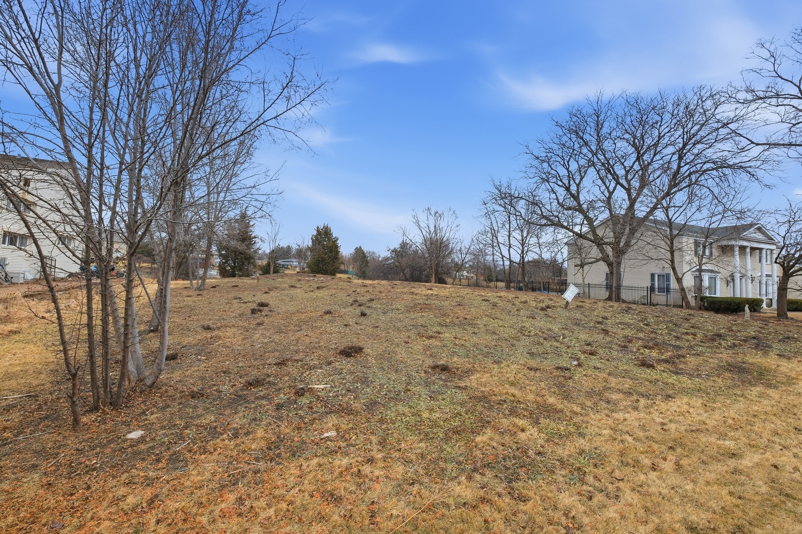 a view of a yard covered with snow in front of house