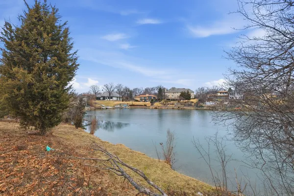 a view of a lake with houses in the back
