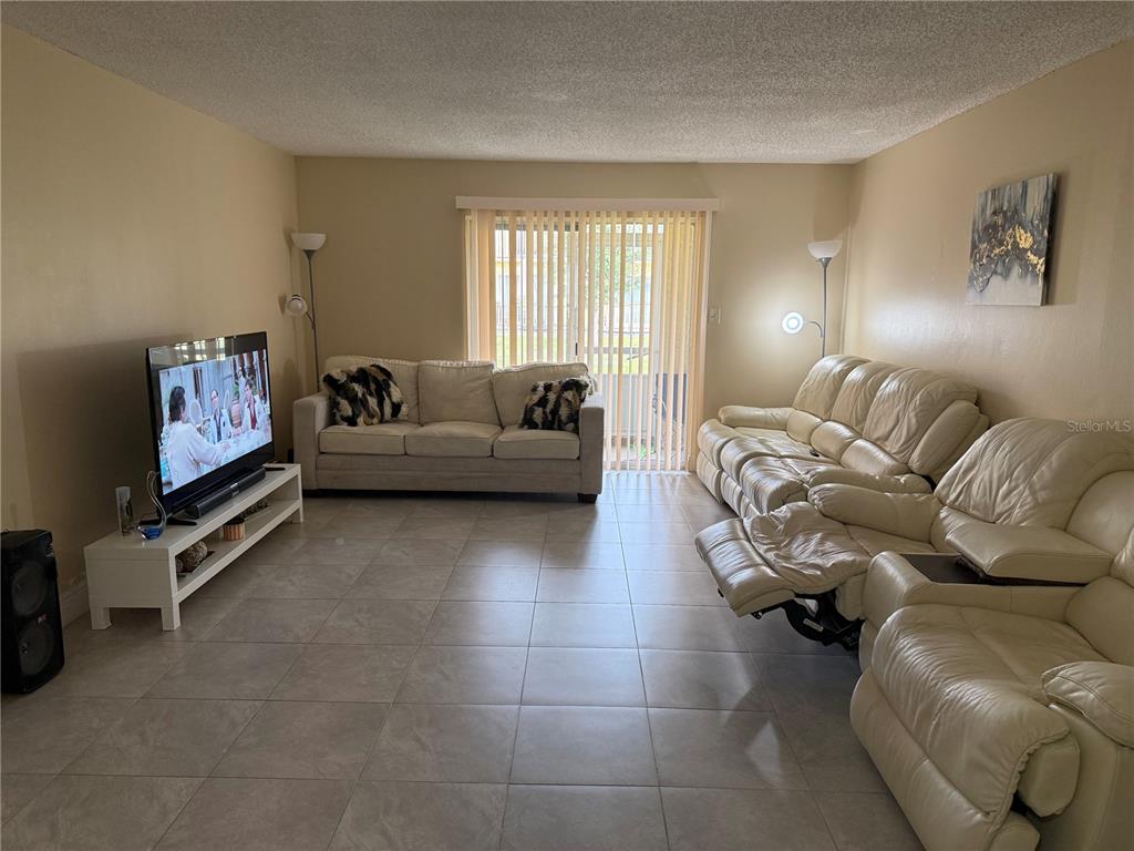 7605 Abonado Road, Unit 7605 Tampa, FL 33615 - Photo 3 of 13 a living room with furniture gym equipment and a window