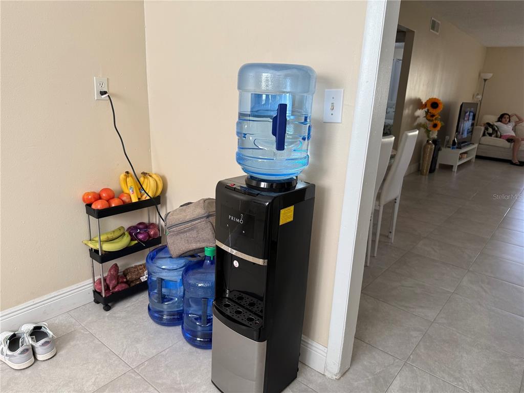 7605 Abonado Road, Unit 7605 Tampa, FL 33615 - Photo 8 of 13 a living room with furniture and a gym machine