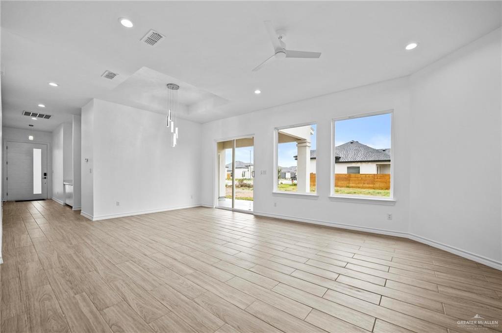 2716 East Conroe Road Edinburg, TX 78542 - Photo 5 of 31 Unfurnished living room with ceiling fan, light wood-style floors, and recessed lighting