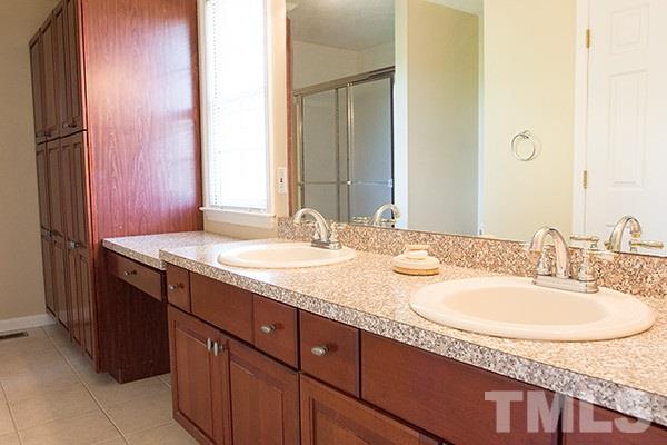 3540 Antioch Church Road Timberlake, NC 27583 - Photo 15 of 25 a bathroom with a granite countertop sink and a mirror