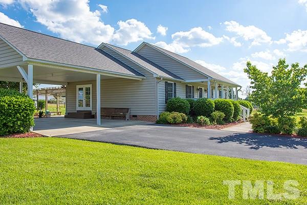 3540 Antioch Church Road Timberlake, NC 27583 - Photo 7 of 25 a front view of a house with a yard and garage