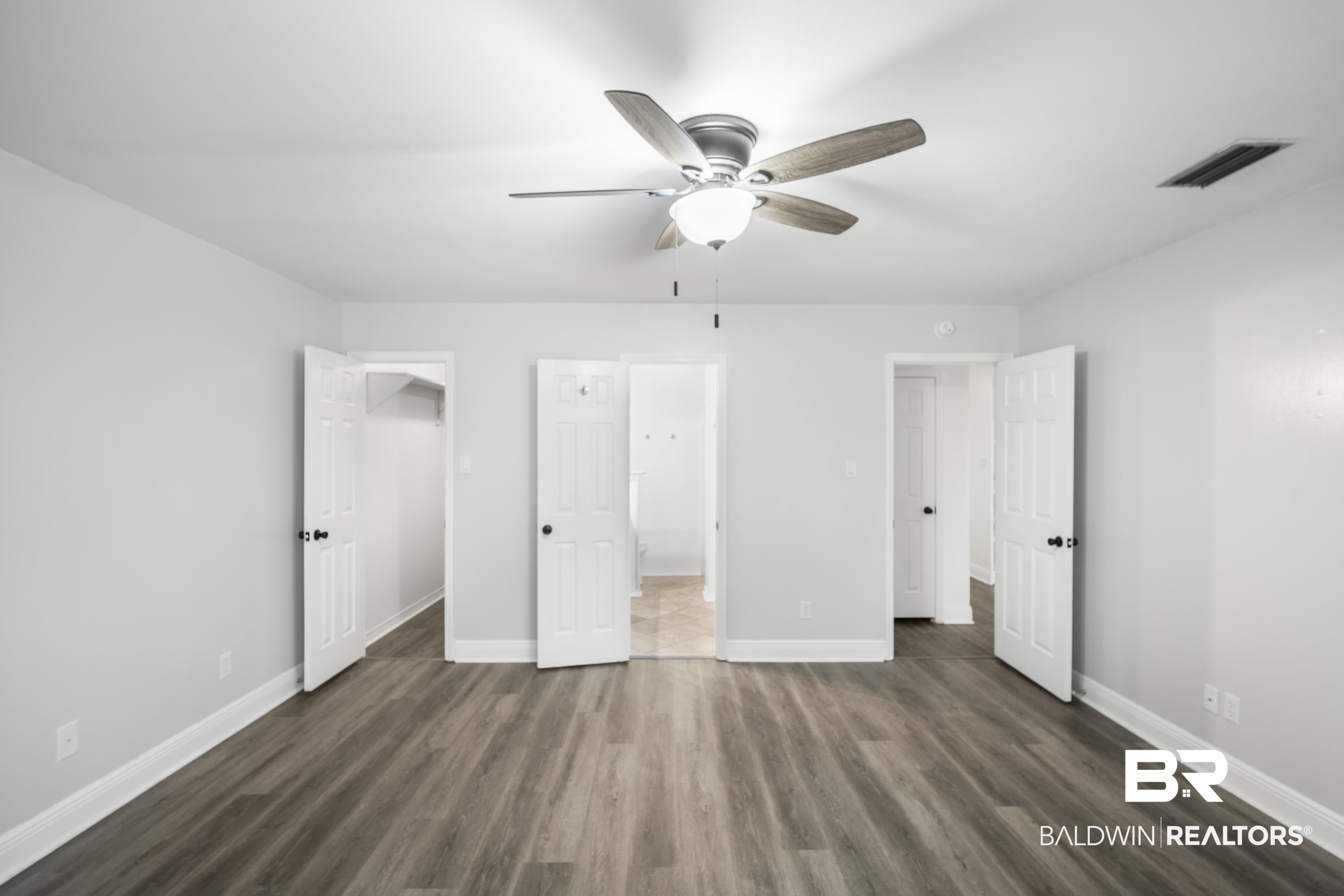 3101 Autumn Ridge Drive West Mobile, AL 36695 - Photo 15 of 36 Unfurnished bedroom with connected bathroom, ceiling fan, and dark wood-type flooring