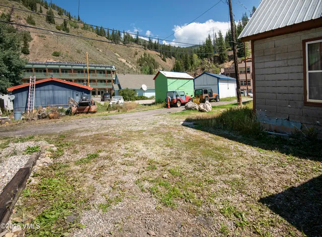 a view of a house with a yard and pathway