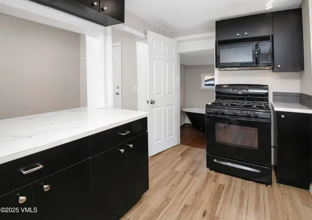 a kitchen with a stove and a microwave