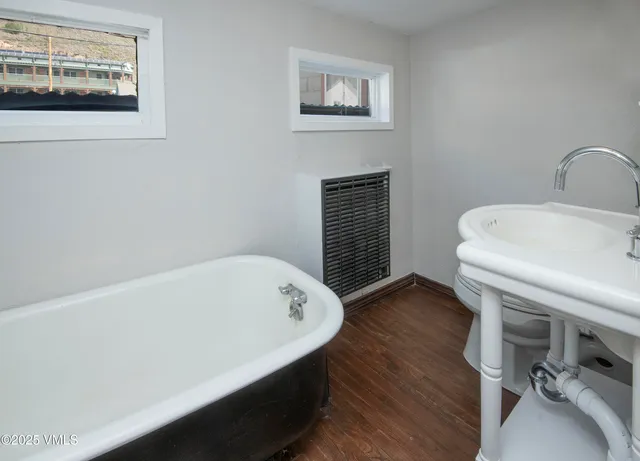a bathroom with a tub and a sink