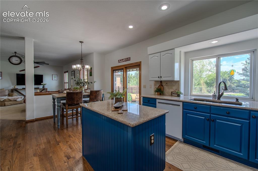 789 Capeglen Road Colorado Springs, CO 80906 - Photo 21 of 46 Open concept to Family room and the flow to the backyard space through french doors is perfect for hosting