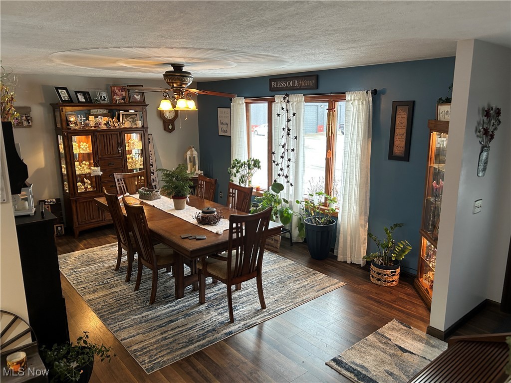 530 Midvale Mine Road Southeast Dennison, OH 44621 - Photo 17 of 42 Dining room featuring dark wood-style flooring, a textured ceiling, and ceiling fan