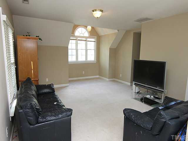 9404 Stone Mountain Road Raleigh, NC 27613 - Photo 12 of 25 Large Bonus Room with Back Stairs Leading to the Kitchen Area. A Great Entertainment, TV and/or Video Game Space! Bonus Room
