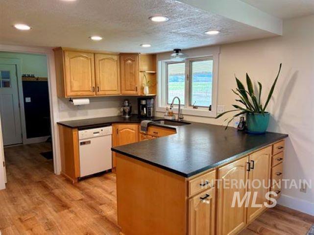 3197 Neeley Road American Falls, ID 83211 - Photo 7 of 45 Kitchen featuring wood-finish flooring, recessed lighting, wood cabinetry, and a central island with countertop space