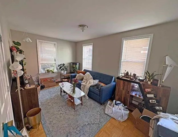a bedroom with bed and wooden floor