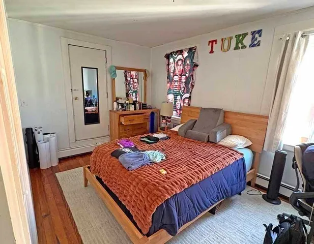 a bed sitting in a bedroom next to a window