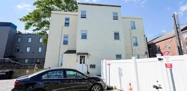 a front view of a house with parking space