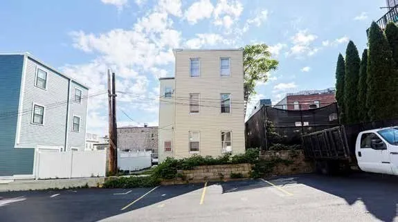a view of cars parked in front of a house