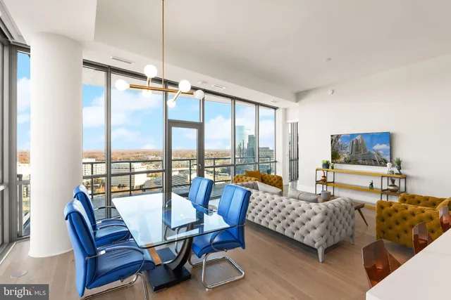 a kitchen with a table a refrigerator a stove a dining table and chairs