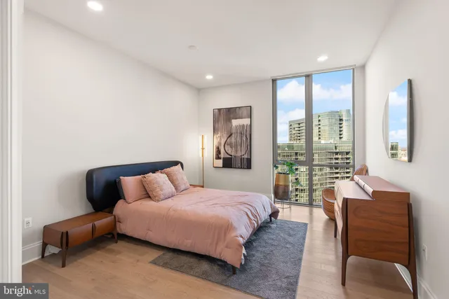 a bedroom with a bed and a night stand