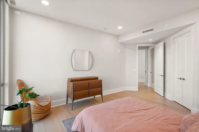 a bedroom with a large bed and a large window