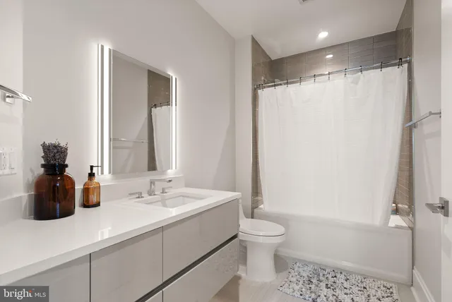 a bedroom with a bed and large windows