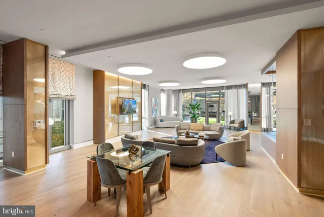 a view of a patio with couches chairs and a table and chairs with wooden fence