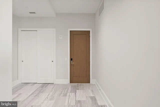 a living room with furniture and floor to ceiling windows