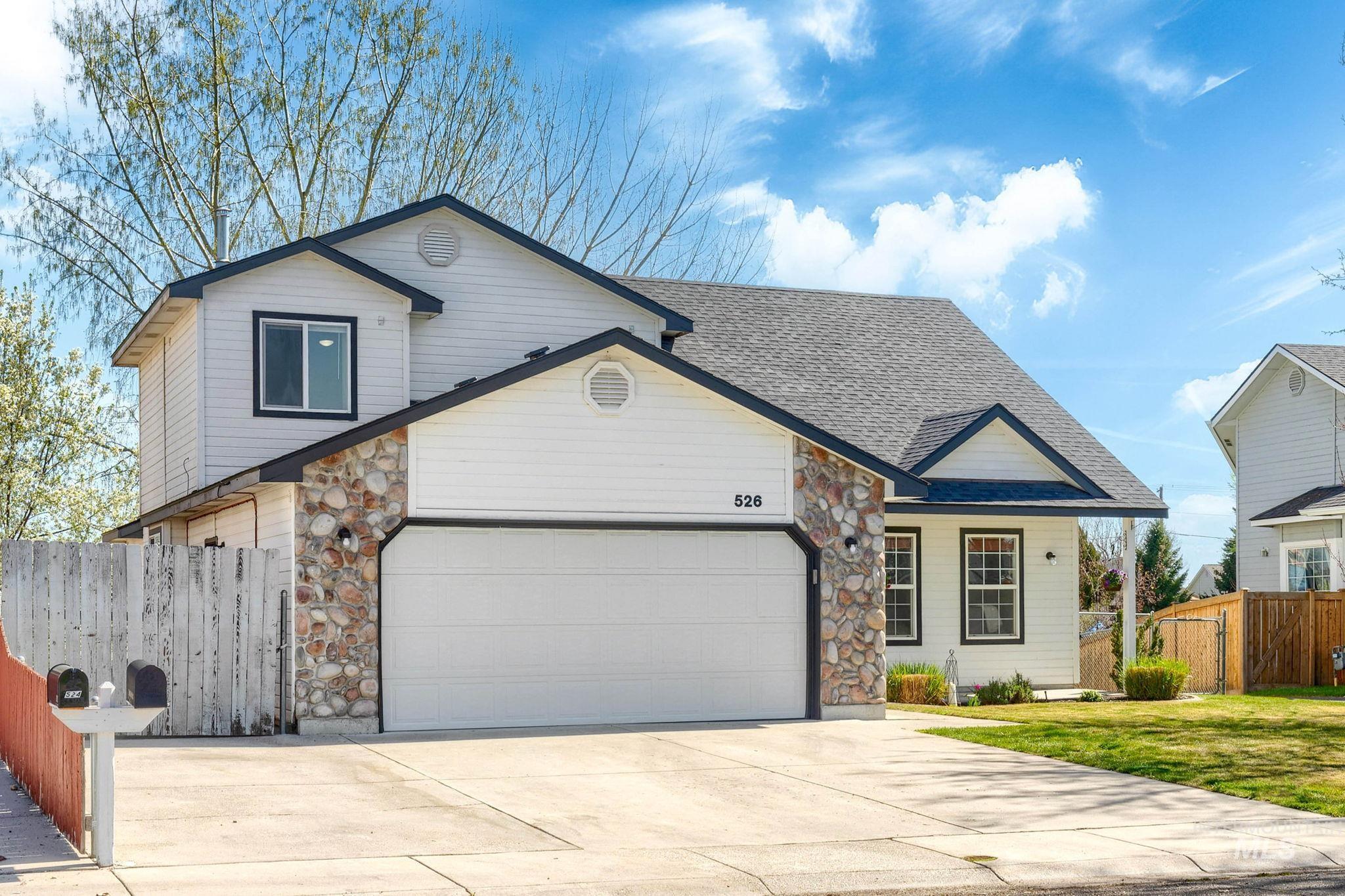 526 Cornwall Way Fruitland, ID 83619 - Photo 3 of 42 View of front of home with stone siding, an attached garage, a shingled roof, and concrete driveway
