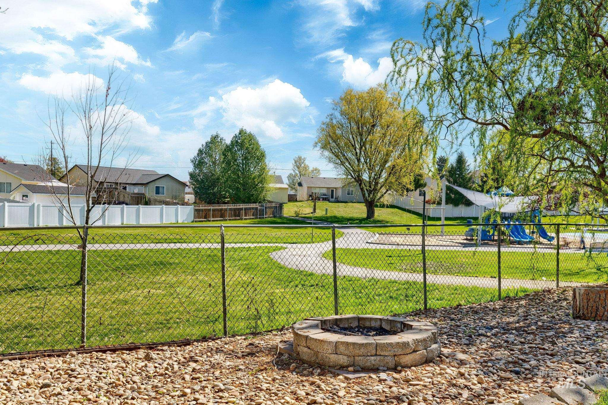 526 Cornwall Way Fruitland, ID 83619 - Photo 41 of 42 View of yard featuring an outdoor fire pit and a residential view
