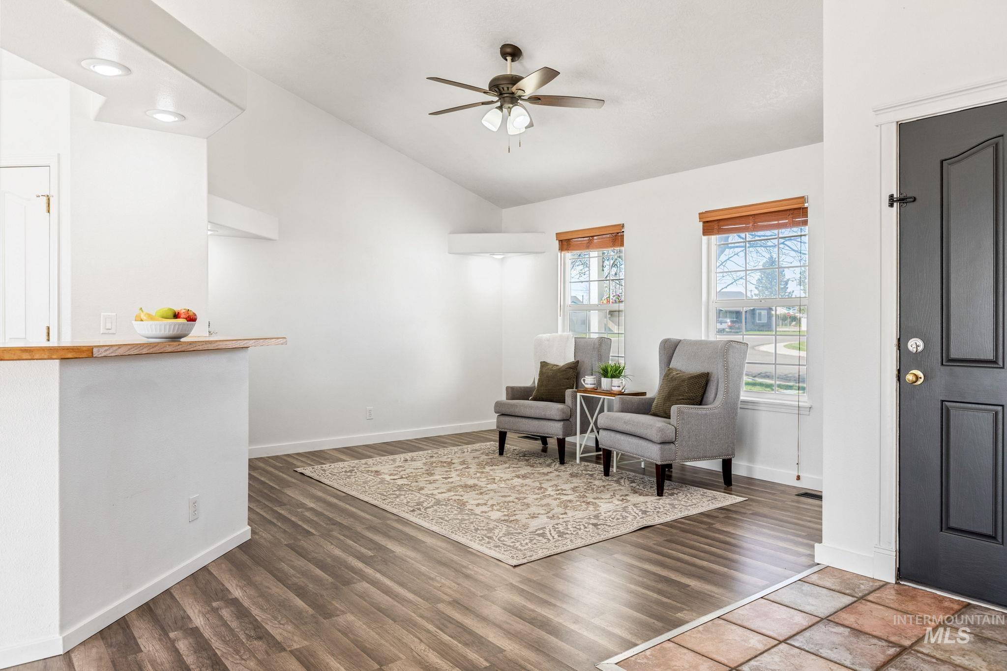 526 Cornwall Way Fruitland, ID 83619 - Photo 5 of 42 Living area featuring lofted ceiling, ceiling fan, and dark wood-style flooring