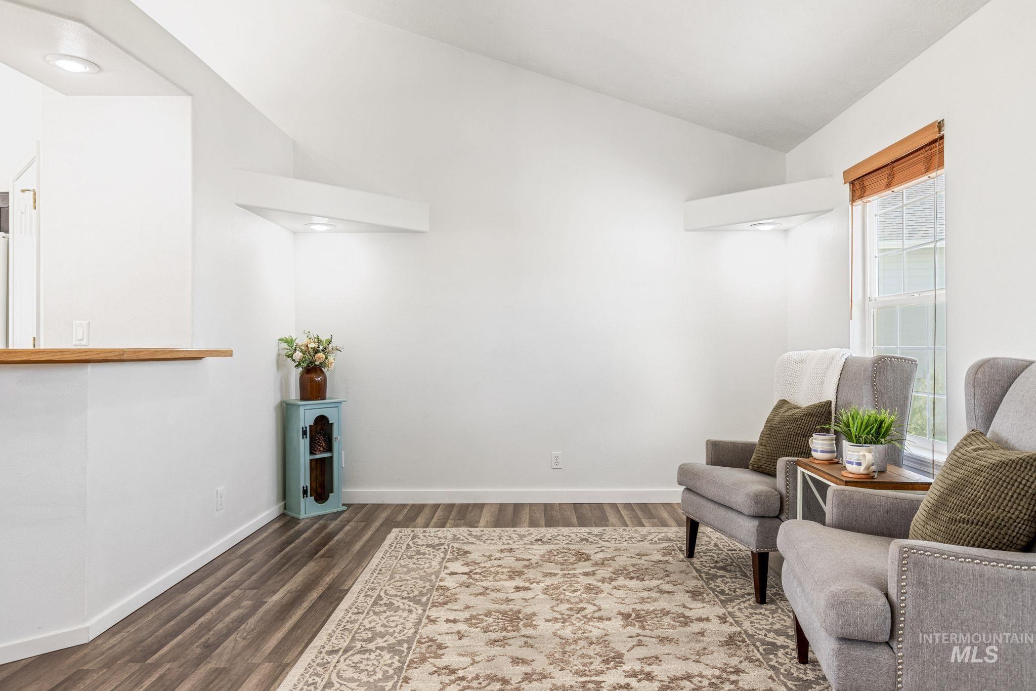 526 Cornwall Way Fruitland, ID 83619 - Photo 6 of 42 Sitting room featuring vaulted ceiling and dark wood-style floors