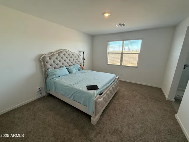 a bedroom with a bed and window