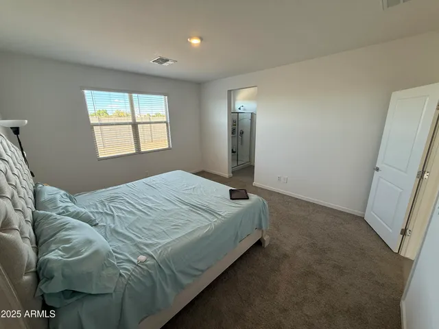 a bed sitting in a bedroom next to a window