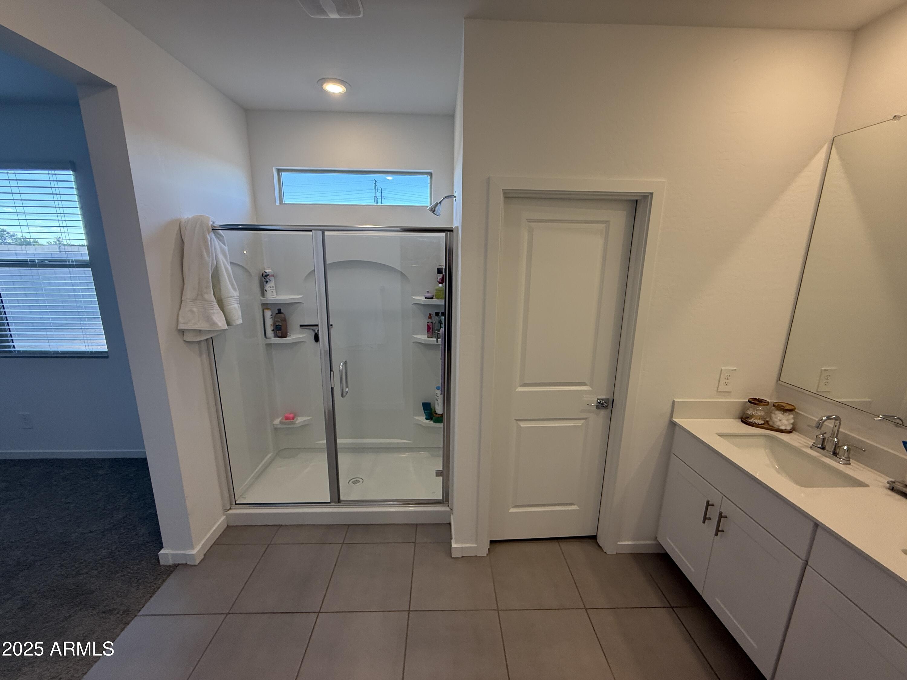 8534 West Warner Street Tolleson, AZ 85353 - Photo 16 of 36 a bathroom with a shower and a sink