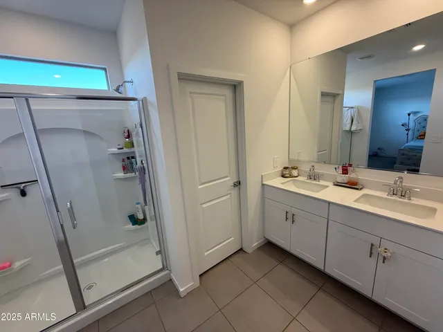 a bathroom with a double vanity sink and mirror