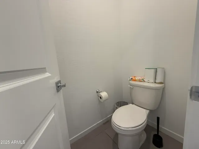a white toilet sitting next to a white sink