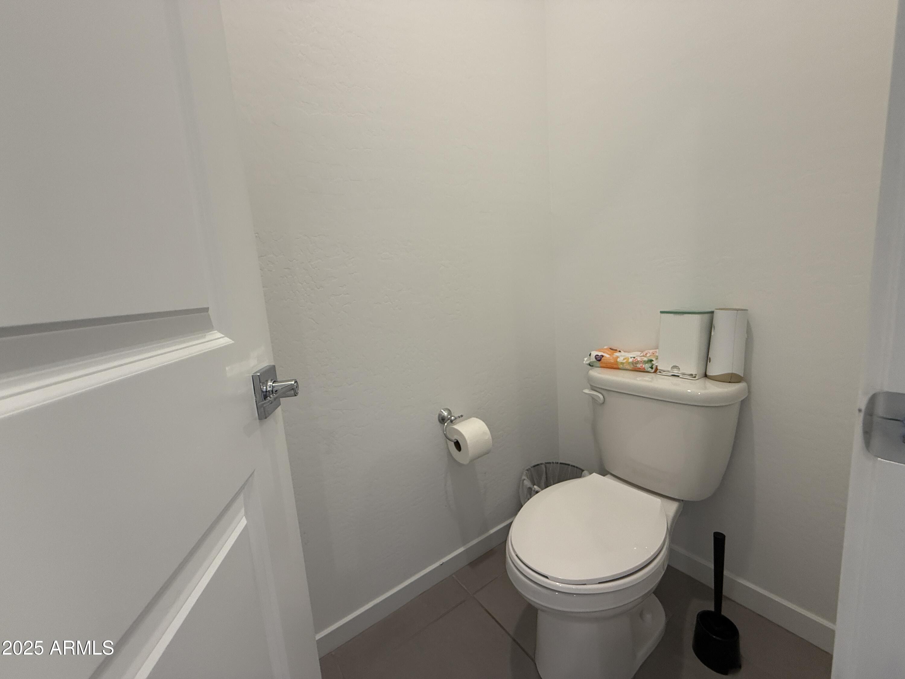 8534 West Warner Street Tolleson, AZ 85353 - Photo 18 of 36 a white toilet sitting next to a white sink