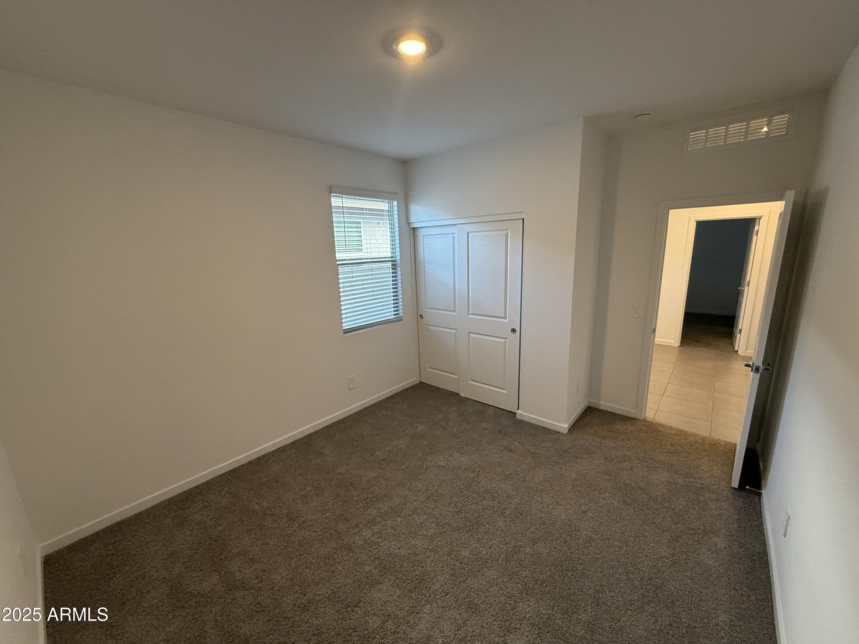 8534 West Warner Street Tolleson, AZ 85353 - Photo 23 of 36 an empty room with windows