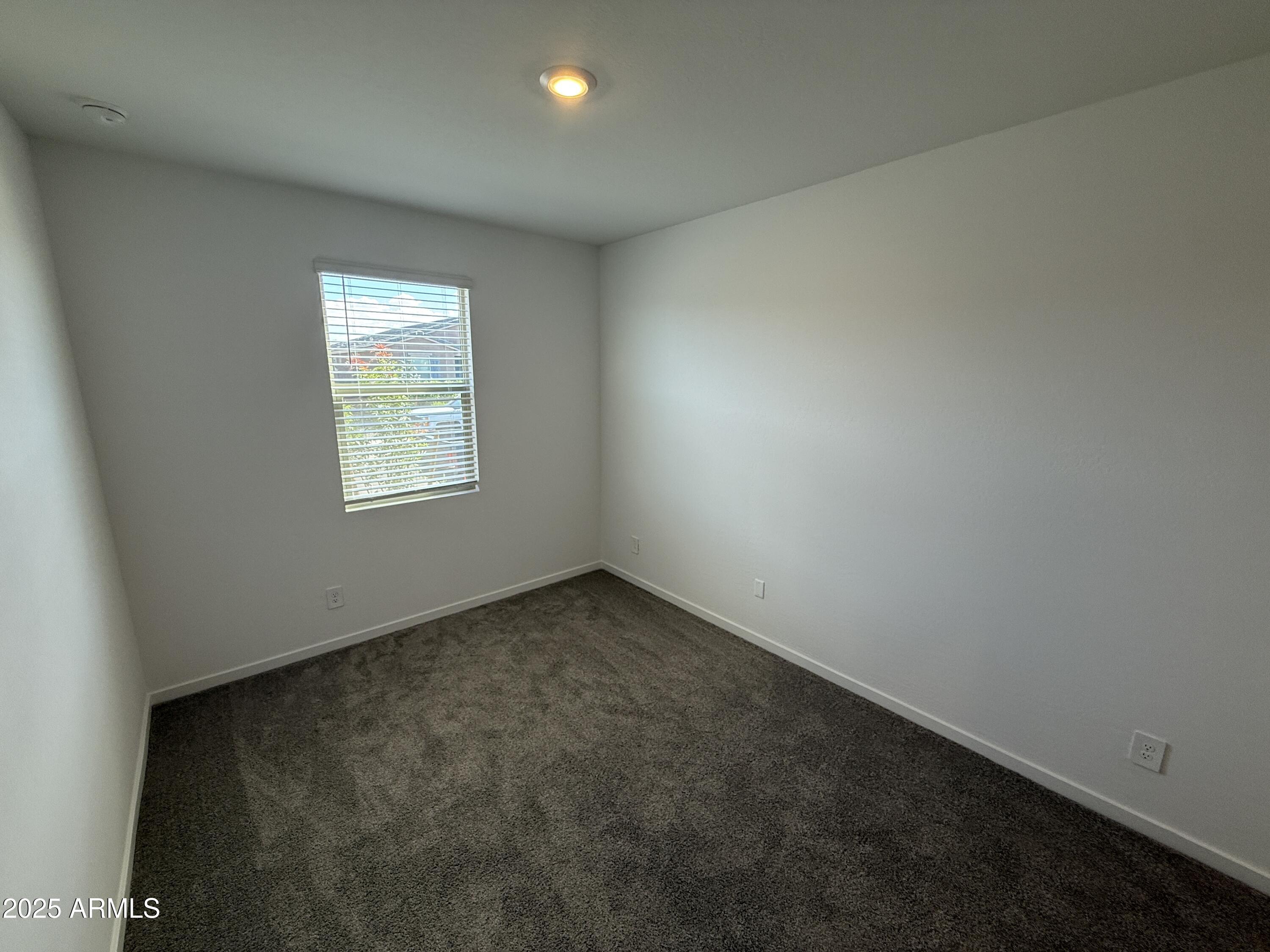 8534 West Warner Street Tolleson, AZ 85353 - Photo 24 of 36 an empty room with a window