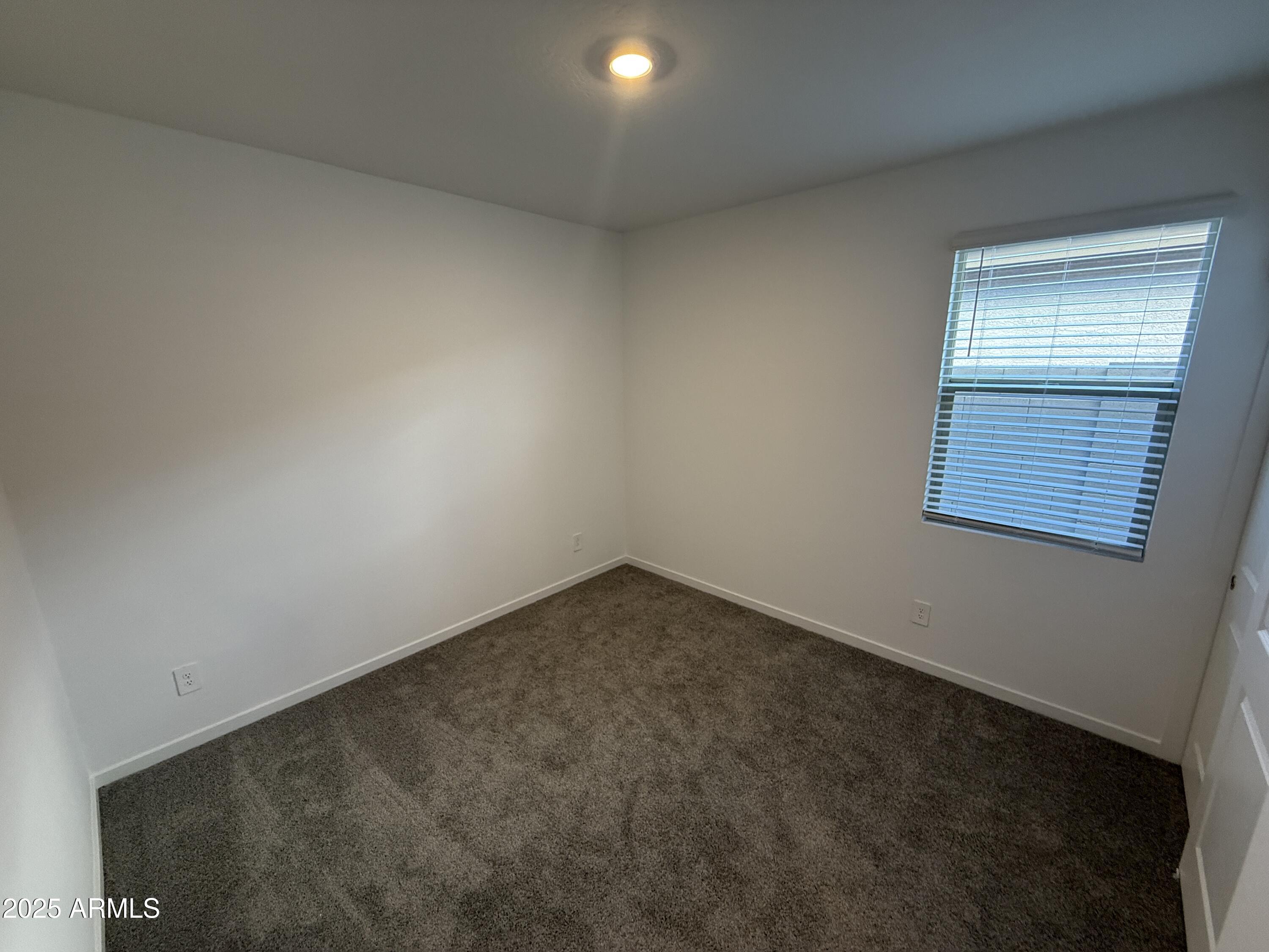 8534 West Warner Street Tolleson, AZ 85353 - Photo 26 of 36 an empty room with a window