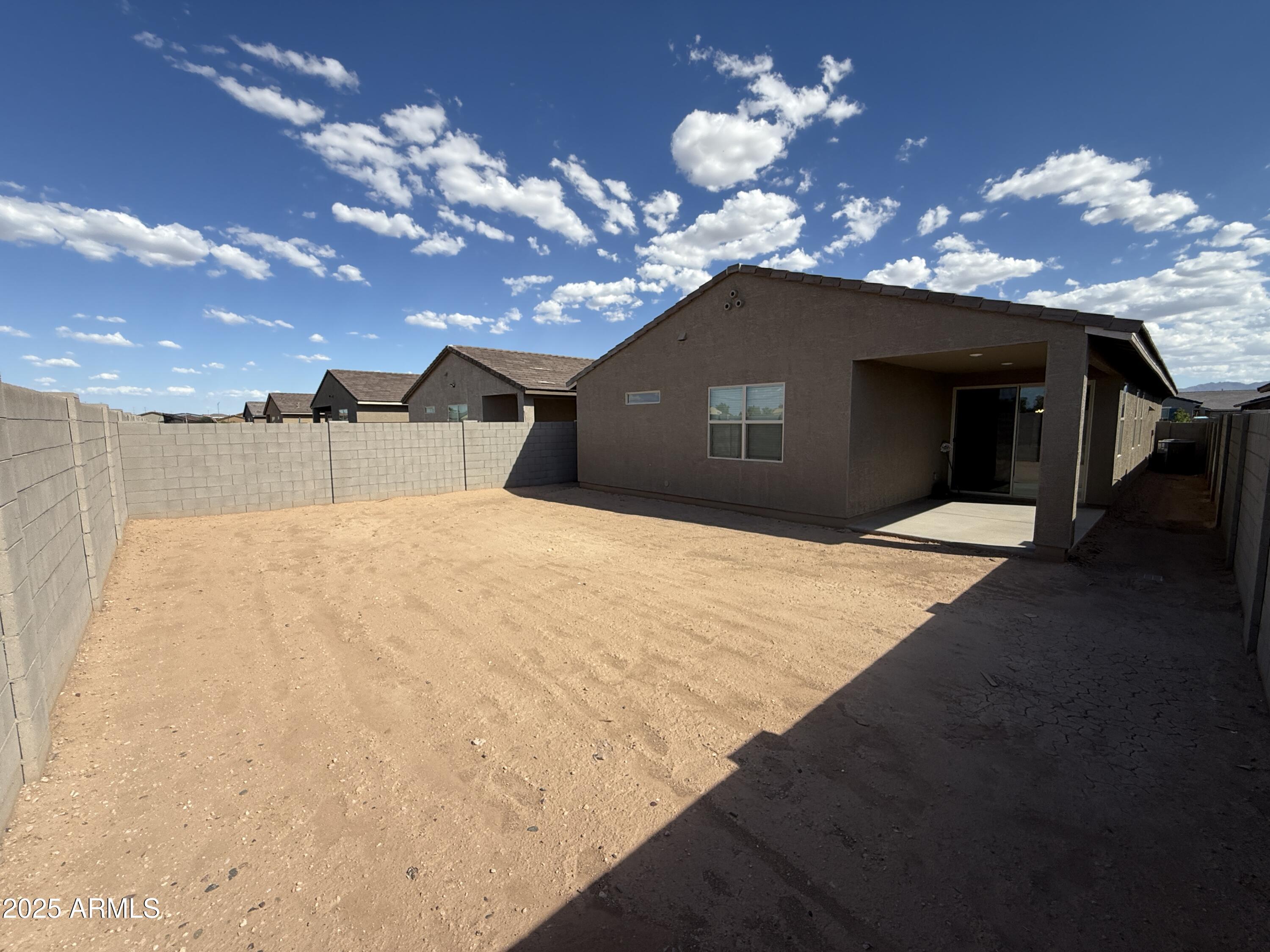 8534 West Warner Street Tolleson, AZ 85353 - Photo 27 of 36 a bedroom with a large bed and a chandelier
