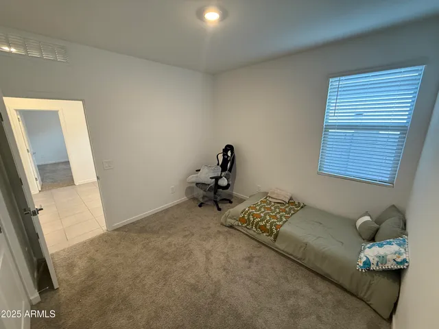a bedroom with furniture and a window