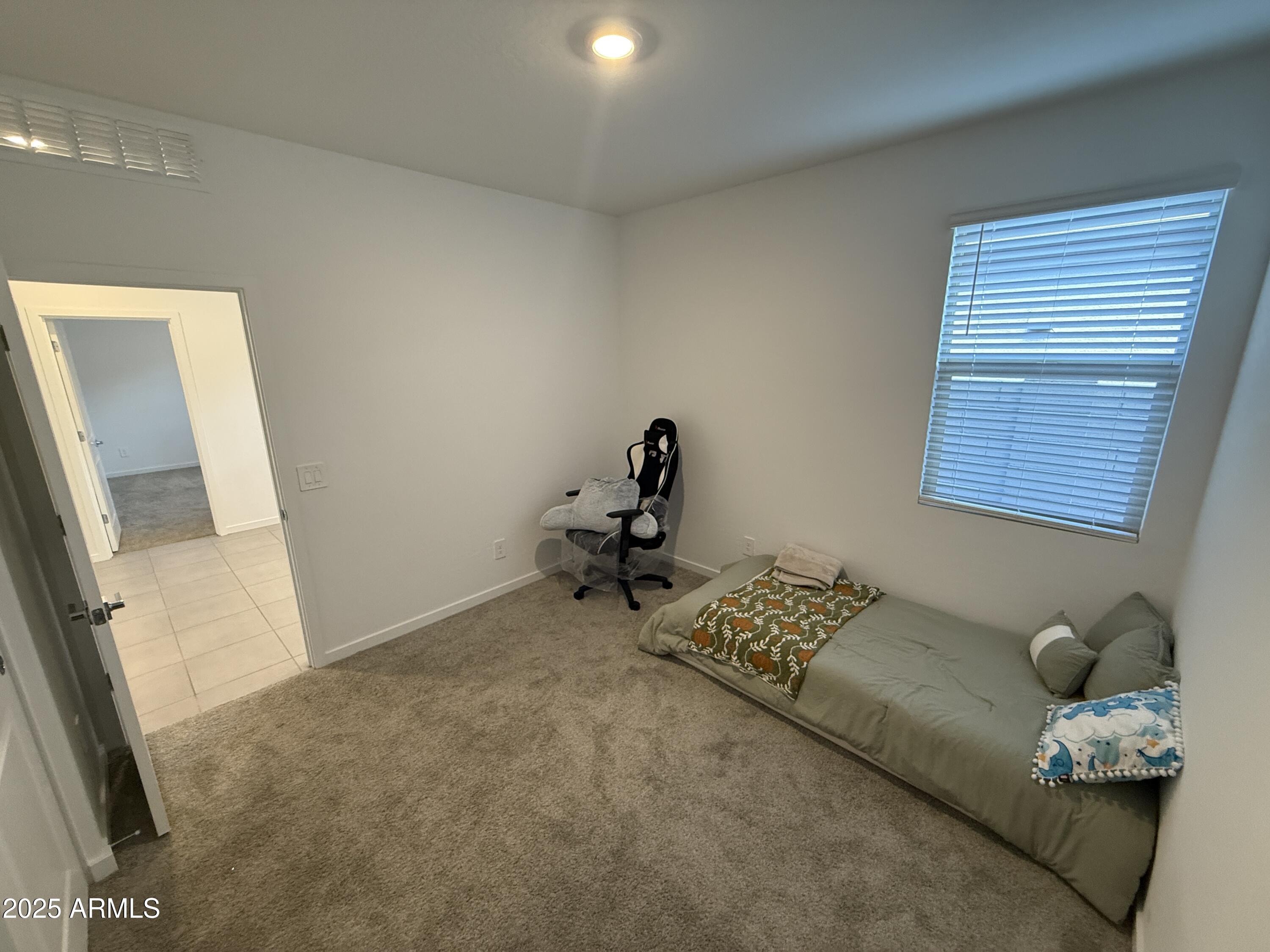 8534 West Warner Street Tolleson, AZ 85353 - Photo 30 of 36 a bedroom with furniture and a window