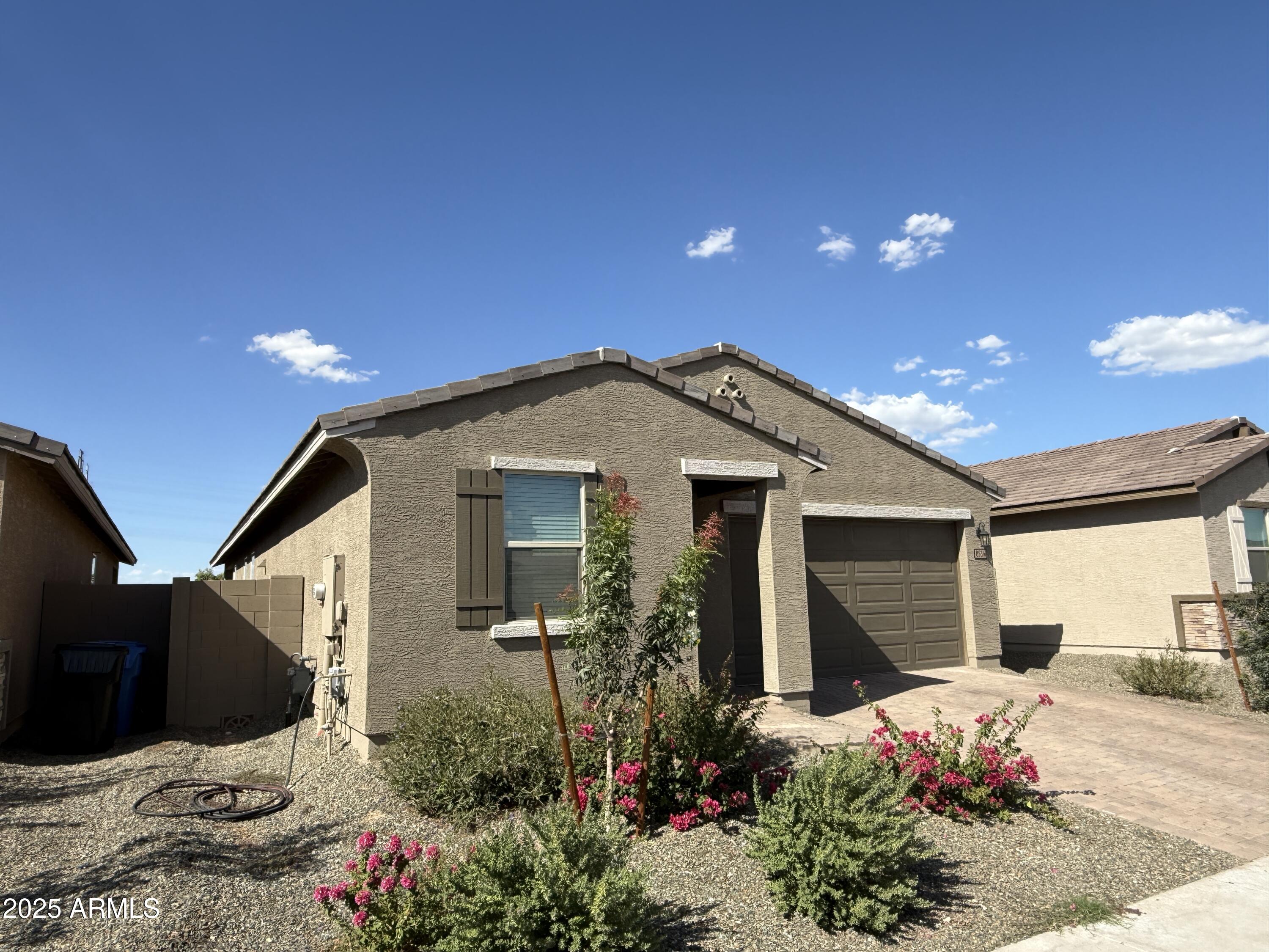 8534 West Warner Street Tolleson, AZ 85353 - Photo 3 of 36 a front view of a house with a yard