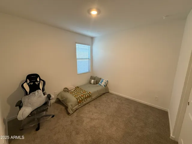 a bedroom with bed and a window