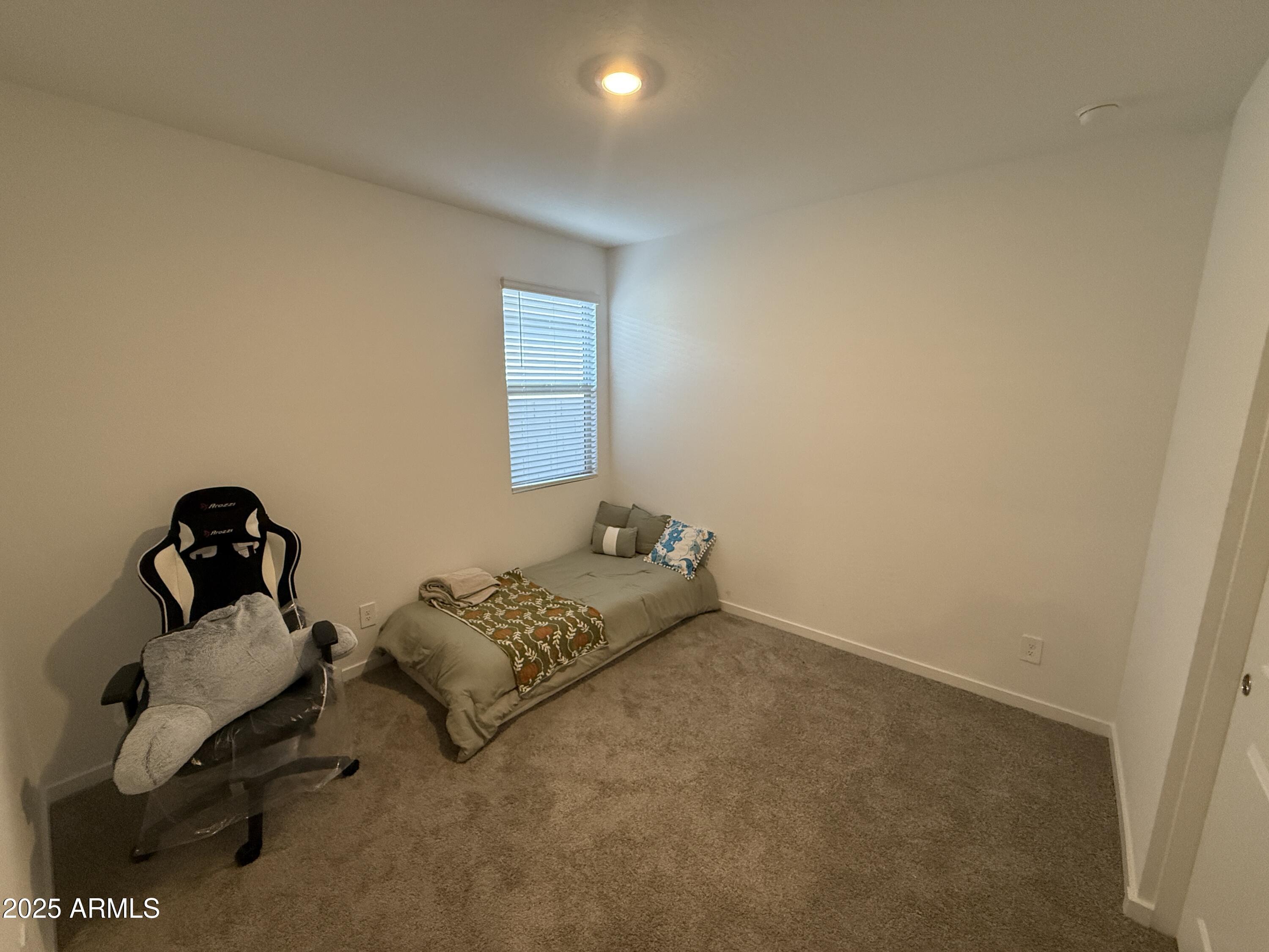 8534 West Warner Street Tolleson, AZ 85353 - Photo 33 of 36 a bedroom with bed and a window
