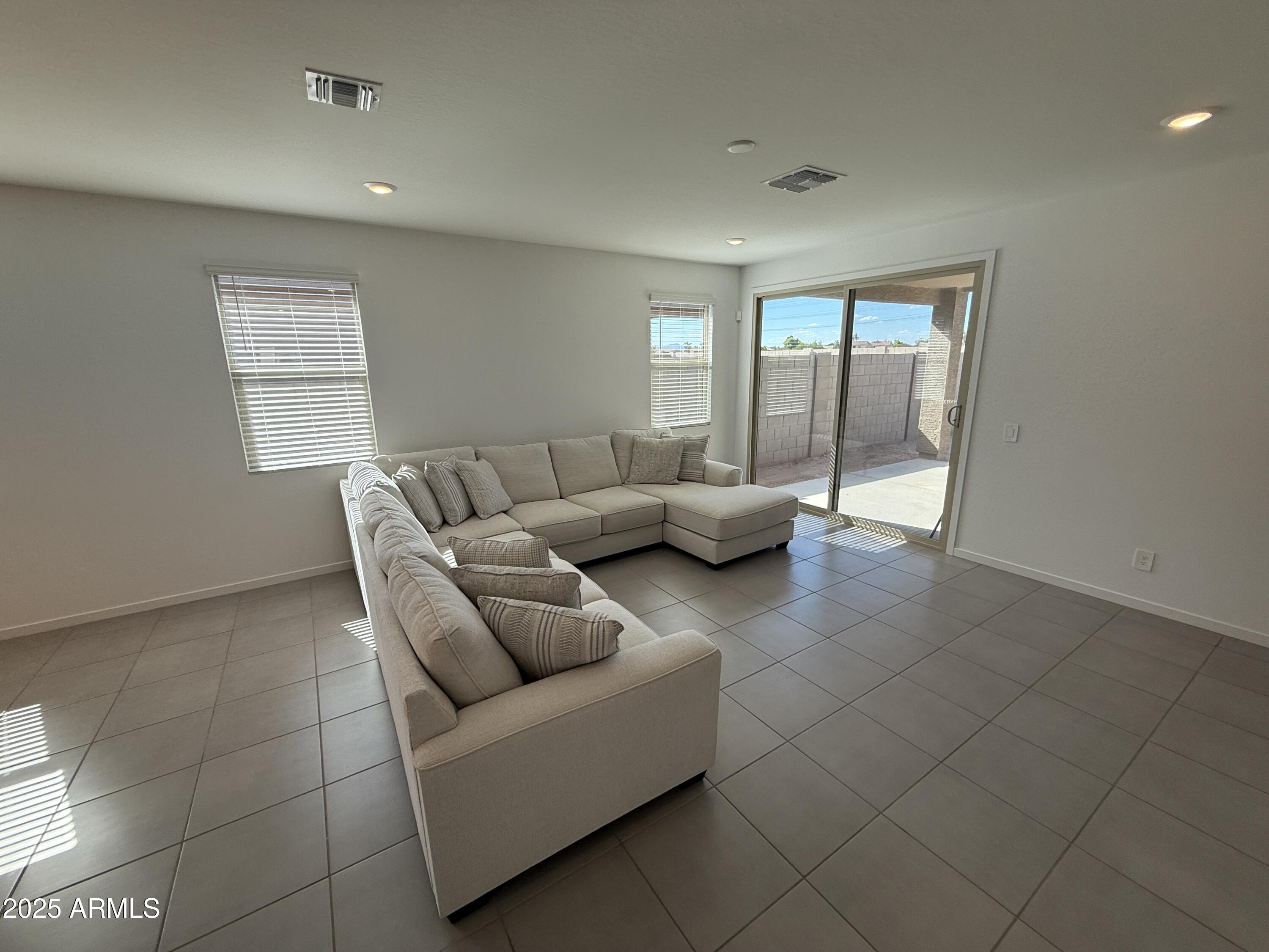 8534 West Warner Street Tolleson, AZ 85353 - Photo 9 of 36 a living room with furniture and a window