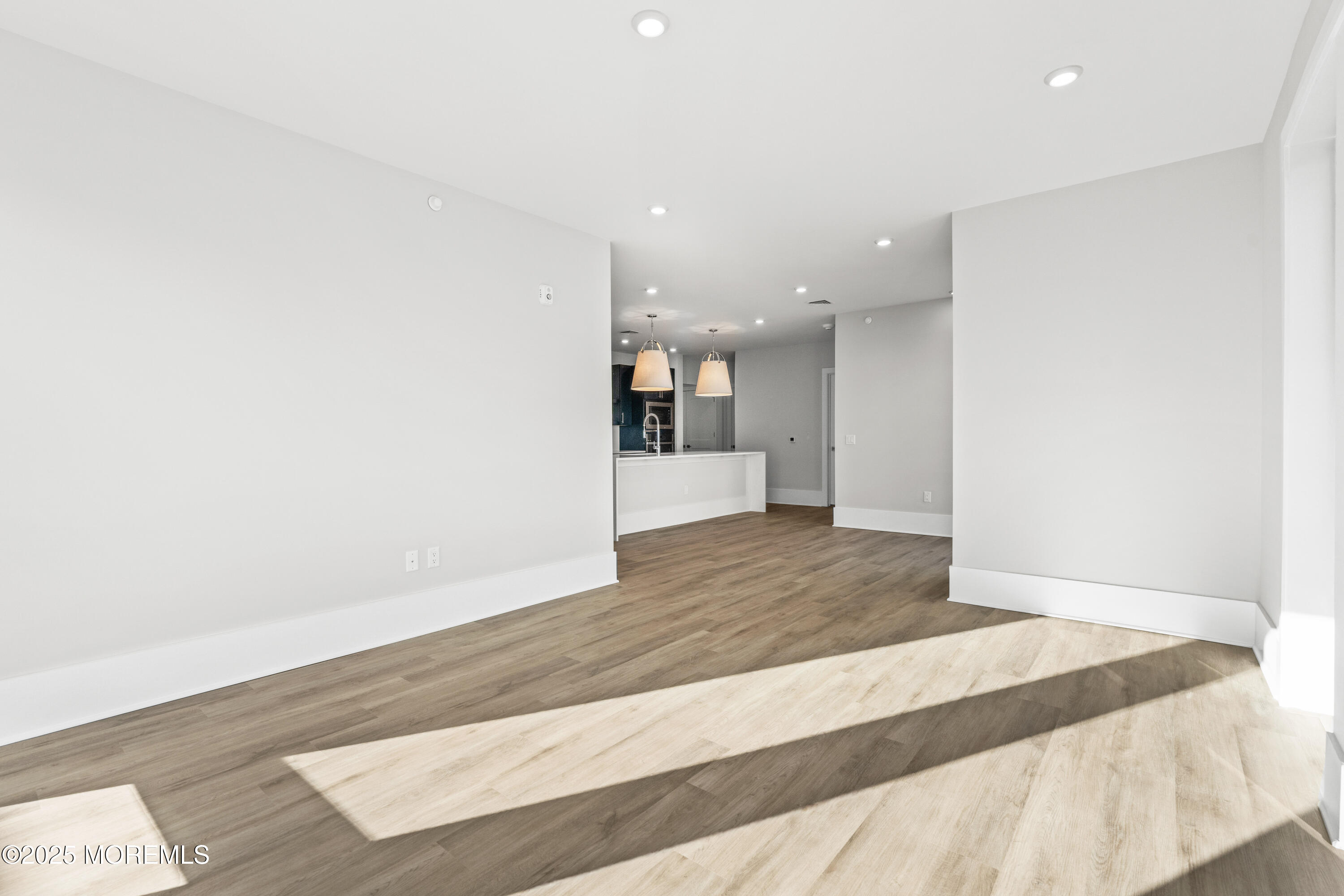 218 3rd Avenue, Unit 306 Asbury Park, NJ 07712 - Photo 27 of 66 a view of an empty room with wooden floor
